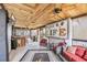 Inviting sunroom boasting wood ceilings, comfortable seating, and a 'Marsh Life' themed decor, perfect for relaxation at 830 Channel Cat Cove, Murrells Inlet, SC 29576