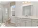 Bright bathroom with white vanity, a glass-enclosed shower, and a window providing natural light at 833 Ireland Dr., Longs, SC 29568