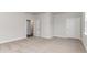 Carpeted bedroom showcasing a neutral color scheme and two entryways at 843 Ireland Dr., Longs, SC 29568