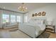 Serene main bedroom with a large window seat, modern lighting, and a comfortable bed, ideal for relaxation at 8518 Jazz Ct. # 77, Myrtle Beach, SC 29572