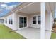 Covered patio with sliding doors to the home and view of the backyard at 8713 High Banks Way, Longs, SC 29568