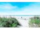 Serene beach with sandy path framed by lush grass, leading to calming ocean views at 8713 High Banks Way, Longs, SC 29568