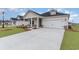 Beautiful home exterior showcasing a long driveway and manicured lawn in a suburban neighborhood at 8713 High Banks Way, Longs, SC 29568