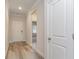 Bright hallway with wood floors, leading to the bedrooms and living spaces at 8713 High Banks Way, Longs, SC 29568