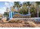 Community entrance sign for Waterside with palm trees and stone base at 8713 High Banks Way, Longs, SC 29568