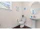 Charming powder room featuring a pedestal sink, decorative fixtures, and seaside-themed decor at 904 Easton Ct., Myrtle Beach, SC 29579