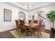 Traditional dining room with arched entrances, a round wood table, and seating for eight at 904 Easton Ct., Myrtle Beach, SC 29579