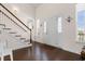 Bright foyer features a white door, gleaming hardwood floors, stairway, and natural light at 904 Easton Ct., Myrtle Beach, SC 29579