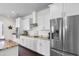 Modern kitchen with stainless steel refrigerator, gas cooktop, white cabinetry, and granite counters at 904 Easton Ct., Myrtle Beach, SC 29579