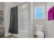 Bathroom with a shower-tub combo, white subway tile, and a modern toilet at 925 Oak Hollow St., Longs, SC 29568