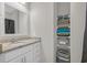 Bathroom featuring a single sink vanity, large mirror, and towel storage at 925 Oak Hollow St., Longs, SC 29568