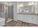 Bathroom featuring double sink vanity, large mirror, and a glass-enclosed walk-in shower at 925 Oak Hollow St., Longs, SC 29568