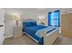 Bedroom featuring a queen size bed with blue bedding, and a bedside table at 925 Oak Hollow St., Longs, SC 29568