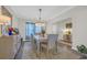 Elegant dining room with modern chandelier, stylish curtains, and room for six, perfect for hosting dinners at 925 Oak Hollow St., Longs, SC 29568