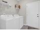 Bright laundry area with modern white washer and dryer units, and ample storage space at 925 Oak Hollow St., Longs, SC 29568