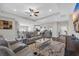 Open concept living room with tray ceiling that connects to the kitchen and dining, perfect for entertaining guests at 925 Oak Hollow St., Longs, SC 29568