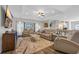 Spacious living room with tray ceiling, lots of seating, and sliding glass doors that provide natural light at 925 Oak Hollow St., Longs, SC 29568