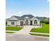 Beautiful single-story home with a manicured lawn, arched windows, and a symmetrical facade at Tbb Lot #3 Lakeside Dr., Conway, SC 29526