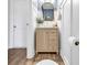 Stylish powder room with a wood vanity, blue patterned wall paper, and wood flooring at 1012 Baker Creek Loop, Myrtle Beach, SC 29579