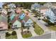 Aerial view of the home in a neighborhood featuring palm trees and colorful beach houses at 1032 N Ocean Blvd., Surfside Beach, SC 29575