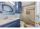 Charming bathroom with a modern vanity, decorative mirror and walk-in shower at 1032 N Ocean Blvd., Surfside Beach, SC 29575