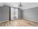 This bedroom features grey walls, wood flooring, and a ceiling fan at 1032 N Ocean Blvd., Surfside Beach, SC 29575