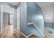 Hallway with wood flooring leads to bedrooms, stairway to the upper and lower levels at 1032 N Ocean Blvd., Surfside Beach, SC 29575