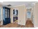Open hallway, with wood floors, paneled walls, leading to the kitchen and other rooms at 1032 N Ocean Blvd., Surfside Beach, SC 29575