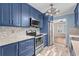 Updated kitchen features stainless steel appliances, stylish cabinets, and a modern tile backsplash at 1032 N Ocean Blvd., Surfside Beach, SC 29575