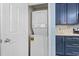 This laundry closet features a stacked washer and dryer, and cabinets above at 1032 N Ocean Blvd., Surfside Beach, SC 29575