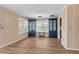 Living room with wood floors, paneled walls, built-in blue cabinets, and plenty of natural light at 1032 N Ocean Blvd., Surfside Beach, SC 29575