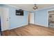 Spacious main bedroom with en-suite bathroom, wood-look flooring and modern ceiling fan at 1032 N Ocean Blvd., Surfside Beach, SC 29575