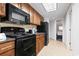 Kitchen featuring modern appliances, wooden cabinets, and granite countertops at 1105 S Ocean Blvd. # 1134, Myrtle Beach, SC 29577