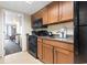 Kitchen with a stove, microwave, and sink with wooden cabinets at 1105 S Ocean Blvd. # 1134, Myrtle Beach, SC 29577