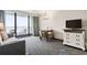 Living room with a sofa, dining table, and balcony access, offering relaxing space at 1105 S Ocean Blvd. # 1134, Myrtle Beach, SC 29577