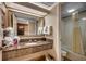 Inviting bathroom features granite counters, a large mirror, and a shower-tub combination with towels at 1105 S Ocean Blvd. # 732, Myrtle Beach, SC 29577