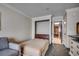 Small bedroom space with a twin bed, a sitting chair and view through the doorway into the kitchen at 1105 S Ocean Blvd. # 732, Myrtle Beach, SC 29577