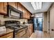 Modern condo kitchen equipped with black appliances, granite countertops, and access to the dining area at 1105 S Ocean Blvd. # 732, Myrtle Beach, SC 29577