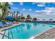 Sparkling outdoor pool with rows of lounge chairs, palm trees, and blue skies offer a relaxing escape at 1105 S Ocean Blvd. # 732, Myrtle Beach, SC 29577