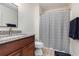 Neutral bathroom with granite vanity, commode and shower with striped curtain at 1250 River Oaks Dr. # 16B, Myrtle Beach, SC 29579