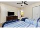 Bedroom with a ceiling fan, twin beds, and dresser, offers a comfortable and stylish retreat at 1250 River Oaks Dr. # 16B, Myrtle Beach, SC 29579