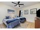 Bright bedroom features two beds, ceiling fan, tiled floors, and beach-themed artwork at 1250 River Oaks Dr. # 16B, Myrtle Beach, SC 29579