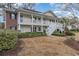 Two-story condo building with white railings and front lawn area at 1250 River Oaks Dr. # 16B, Myrtle Beach, SC 29579