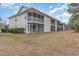 Two-story condo building with multiple screened porches overlooking the yard at 1250 River Oaks Dr. # 16B, Myrtle Beach, SC 29579