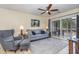 Comfortable living room with a ceiling fan, sliding glass doors, and neutral decor at 1250 River Oaks Dr. # 16B, Myrtle Beach, SC 29579