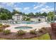 Outdoor pool and jacuzzi with lounge chairs surrounded by trees and landscaping under a partly cloudy sky at 1250 River Oaks Dr. # 16B, Myrtle Beach, SC 29579