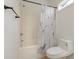 This bathroom features a shower/bathtub combo with a decorative curtain and a modern toilet at 130 Lazy Willow Ln. # 204, Myrtle Beach, SC 29588