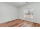 Cozy bedroom featuring wood floors and bright natural light from a large window at 130 Lazy Willow Ln. # 204, Myrtle Beach, SC 29588