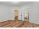 This bedroom features an open design, wood flooring, and doors leading to the bathroom and hallway at 130 Lazy Willow Ln. # 204, Myrtle Beach, SC 29588