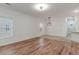Open living area featuring wood flooring, ample natural light, and stylish light fixture at 130 Lazy Willow Ln. # 204, Myrtle Beach, SC 29588